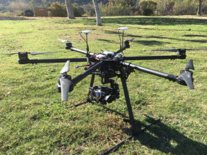 Hexacopter with a camera mounted on board parked on the grass